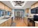 Bright kitchen with wooden cabinets, stainless steel appliances, and a breakfast nook area at 6490 Pine Meadows Dr, Spring Hill, FL 34606