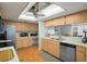 A spacious kitchen featuring light wood cabinets, modern appliances, and an eating bar at 6490 Pine Meadows Dr, Spring Hill, FL 34606