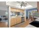 A home kitchen with wooden cabinets, stainless steel appliances, and an adjacent seating area at 6490 Pine Meadows Dr, Spring Hill, FL 34606
