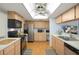 A view of a kitchen with sleek appliances and wooden cabinets in a cozy setting at 6490 Pine Meadows Dr, Spring Hill, FL 34606