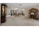 Spacious living area with carpet, display cabinet, natural light and glass coffee table at 6490 Pine Meadows Dr, Spring Hill, FL 34606
