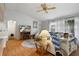 Comfortable living room with cozy seating, natural light, and wood laminate flooring at 6490 Pine Meadows Dr, Spring Hill, FL 34606