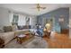 Inviting living room with plush sectional sofa, blue accents, and view of the outdoor pool area at 6490 Pine Meadows Dr, Spring Hill, FL 34606