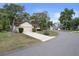 A street view of a well maintained property with curb appeal at 6490 Pine Meadows Dr, Spring Hill, FL 34606
