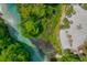Birds-eye view of a community beach with lounge chairs, fire pit, and a river flowing nearby, ideal for recreational activities at 6583 River Run Blvd # 21005, Weeki Wachee, FL 34607