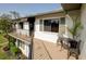Inviting balcony with decorative iron chairs and a small table, creating a cozy spot to relax and enjoy the fresh air and outdoor views at 6583 River Run Blvd # 21005, Weeki Wachee, FL 34607