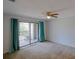 Bright bedroom with a ceiling fan and sliding glass doors to a private balcony at 6583 River Run Blvd # 21005, Weeki Wachee, FL 34607