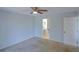 Bedroom with a ceiling fan, carpet, and an open view into the bathroom at 6583 River Run Blvd # 21005, Weeki Wachee, FL 34607