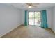 Bright bedroom with sliding glass doors and plush carpet at 6583 River Run Blvd # 21005, Weeki Wachee, FL 34607