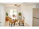 Cozy breakfast nook with glass table, wicker chairs, natural light, and view to the kitchen refrigerator at 6583 River Run Blvd # 21005, Weeki Wachee, FL 34607