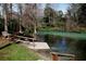 A wooden dock stretches out onto a picturesque river with lush green trees in the background, creating a serene waterfront setting at 6583 River Run Blvd # 21005, Weeki Wachee, FL 34607