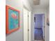 Hallway with a flamingo painting and views into an adjacent room at 6583 River Run Blvd # 21005, Weeki Wachee, FL 34607