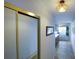 Bright hallway featuring tile floors, closet, and a glimpse of a living area with a balcony view, highlighting the home's layout at 6583 River Run Blvd # 21005, Weeki Wachee, FL 34607