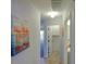 Hallway with built in shelving leading towards an outside balcony and the kitchen area at 6583 River Run Blvd # 21005, Weeki Wachee, FL 34607