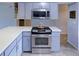 Well-equipped kitchen with stainless steel oven, microwave, and light-colored cabinets, offering modern convenience at 6583 River Run Blvd # 21005, Weeki Wachee, FL 34607