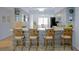 Open concept kitchen with bar seating, pendant lighting, and views to adjacent living area at 6583 River Run Blvd # 21005, Weeki Wachee, FL 34607