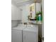 Bright laundry room with white washer and dryer and a water heater at 6583 River Run Blvd # 21005, Weeki Wachee, FL 34607