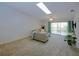 Spacious living room with skylight and sliding glass door to the balcony at 6583 River Run Blvd # 21005, Weeki Wachee, FL 34607