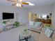 Open-concept living room with neutral decor, comfortable seating and easy access to the kitchen area at 6583 River Run Blvd # 21005, Weeki Wachee, FL 34607