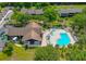 Aerial view of the pristine community pool and spa, surrounded by lush landscaping and lounge chairs at 6583 River Run Blvd # 21005, Weeki Wachee, FL 34607