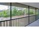 View from a screened porch with greenery in the distance at 6583 River Run Blvd # 21005, Weeki Wachee, FL 34607