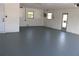 Spacious garage with freshly painted floor, windows, and doors at 7014 Jasmine Blvd, Port Richey, FL 34668