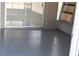 View of a screened patio with a newly painted floor and sliding glass doors at 7014 Jasmine Blvd, Port Richey, FL 34668