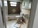 Cozy bathroom with decorative tiled walls, a tub, toilet, and pedestal sink at 7331 Sandalwood Dr, Port Richey, FL 34668
