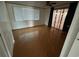 Spacious bedroom featuring wood floors, a large window, and a sliding glass door at 7331 Sandalwood Dr, Port Richey, FL 34668
