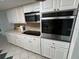 Modern kitchen with white cabinets, stainless steel appliances, and ample counter space for meal preparation at 7331 Sandalwood Dr, Port Richey, FL 34668
