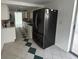 Bright kitchen with white cabinets, stainless steel appliances, and black refrigerator at 7331 Sandalwood Dr, Port Richey, FL 34668