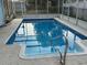 Inviting in-ground pool featuring ladder access and a relaxing spot for leisure and recreation at 7331 Sandalwood Dr, Port Richey, FL 34668
