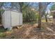 Backyard features a shed, mature trees, providing extra storage and natural beauty at 7464 Acorn Cir, Spring Hill, FL 34606