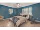 Tranquil bedroom featuring cool blue walls, tiled floors, and a comfortable bed at 7464 Acorn Cir, Spring Hill, FL 34606