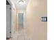 Hallway featuring tile flooring, neutral walls, and visible electrical outlets at 7464 Acorn Cir, Spring Hill, FL 34606