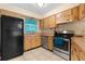 Kitchen with stainless steel appliances, wood cabinets, and a cozy breakfast nook at 7464 Acorn Cir, Spring Hill, FL 34606