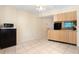 Tile floor kitchen with light-colored cabinets, black appliances, and a breakfast bar at 7464 Acorn Cir, Spring Hill, FL 34606