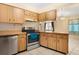 Kitchen featuring stainless steel appliances, wood cabinets, and tile flooring at 7464 Acorn Cir, Spring Hill, FL 34606
