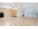 Open floor plan with tile flooring, ceiling fan, and a partial view of the kitchen at 7464 Acorn Cir, Spring Hill, FL 34606