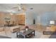 Bright and airy living room with tile floors, ceiling fan, and a dining area at 7464 Acorn Cir, Spring Hill, FL 34606