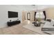 Bright living room featuring tile floors, a modern black cabinet, and a white sofa at 7464 Acorn Cir, Spring Hill, FL 34606