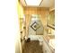 Bathroom featuring unique tile and gold-toned accents at 7632 Lake Forest Cir, Port Richey, FL 34668