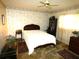 Bedroom with vintage floral wallpaper, ceiling fan, and traditional wood furniture at 7632 Lake Forest Cir, Port Richey, FL 34668