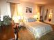 Cozy bedroom with a bed, warm lighting, and classic decor at 7632 Lake Forest Cir, Port Richey, FL 34668