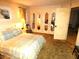 Cozy bedroom featuring a comfortable bed, mirrored closet doors, and warm lighting at 7632 Lake Forest Cir, Port Richey, FL 34668