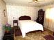 Bedroom with vintage floral wallpaper, ceiling fan, and traditional wood furniture at 7632 Lake Forest Cir, Port Richey, FL 34668