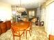 A bright dining room showcases a decorative chandelier and view into the living room at 7632 Lake Forest Cir, Port Richey, FL 34668