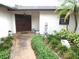 Inviting front entrance with double doors, stone accents, and lush landscaping at 7632 Lake Forest Cir, Port Richey, FL 34668