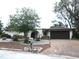 Charming single-story home with rock gardens, wrought iron entry, two car garage, and well manicured lawn at 7632 Lake Forest Cir, Port Richey, FL 34668