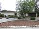 Charming single-story home with a manicured front yard featuring a tree, rock garden, and a two car garage at 7632 Lake Forest Cir, Port Richey, FL 34668